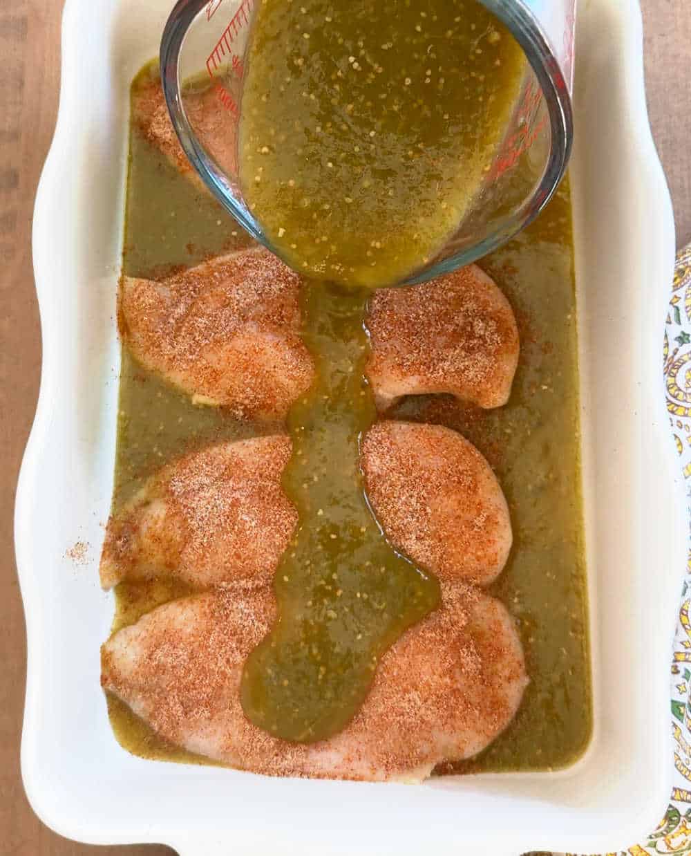 pouring sauce over chicken.