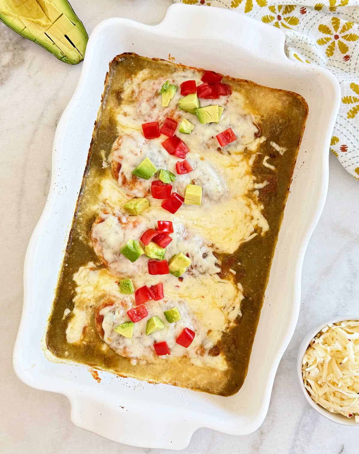 baked salsa verde chicken topped with cheese, tomato and avocado.