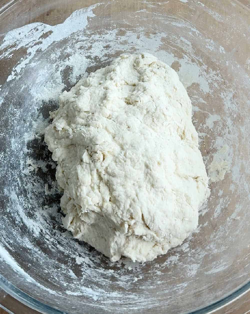 shaggy bread dough in bowl.