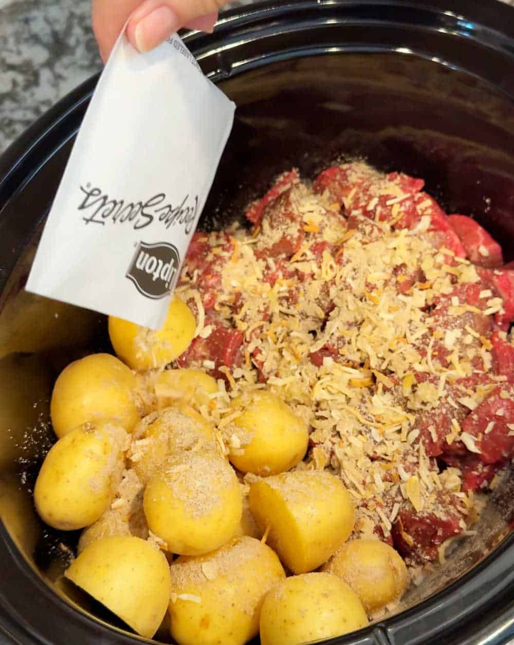sprinkle onion soup mix over stew meat and potatoes.