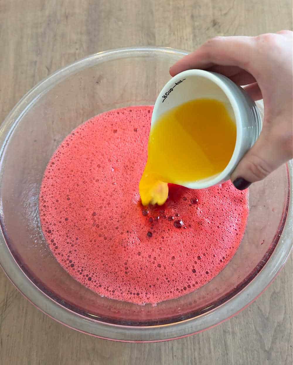 pouring in orange juice.