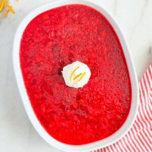 cranberry jello salad with pineapple in serving dish.