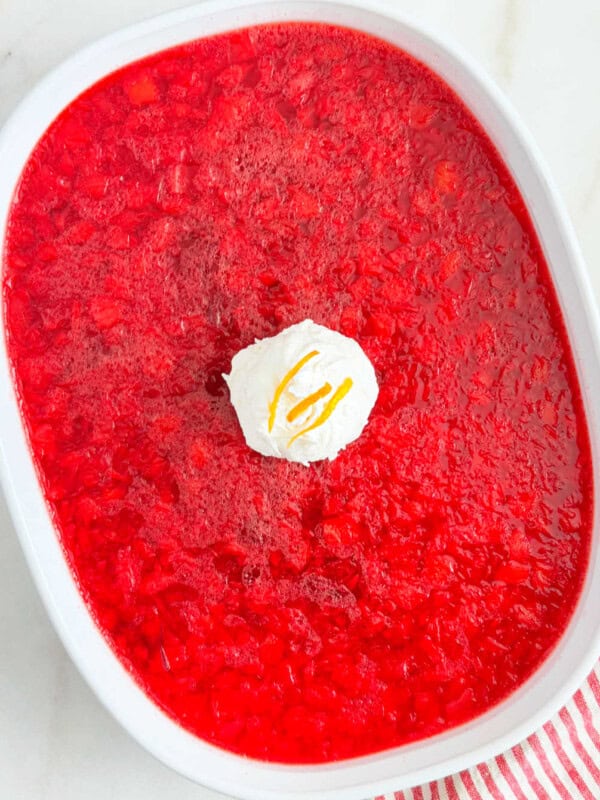 cranberry jello salad with pineapple in serving dish.
