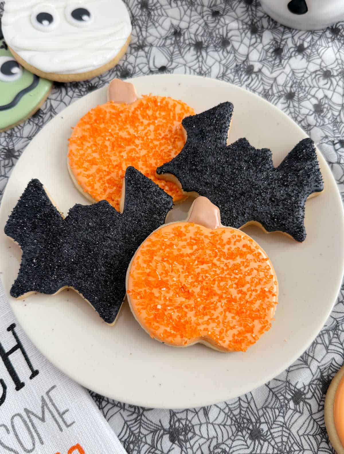 decorated pumpkin and bat cookies.