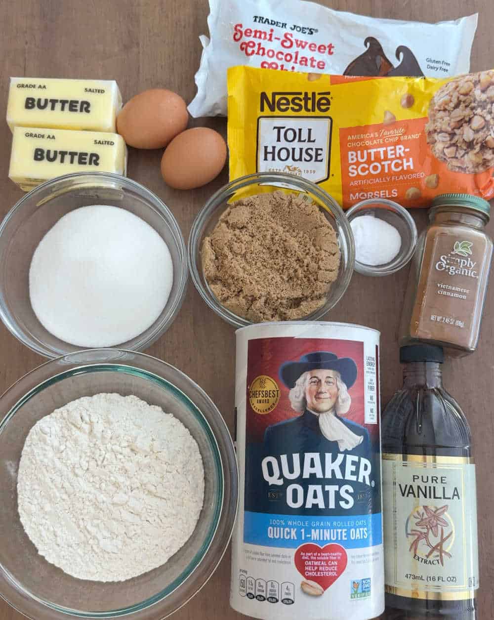 Quaker oats, butterscotch chips and chocolate morsels and ingredients for cookies.