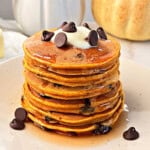 pumpkin chocolate chip pancakes on a plate.