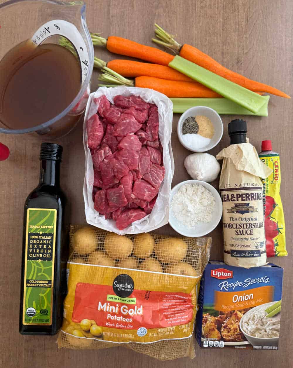 beef stew meat, carrots, potatoes, celery and ingredients for stew.