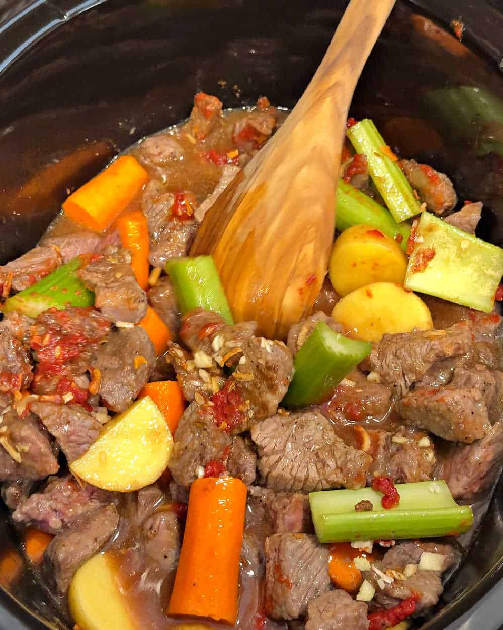 stirring ingredients in crock pot.