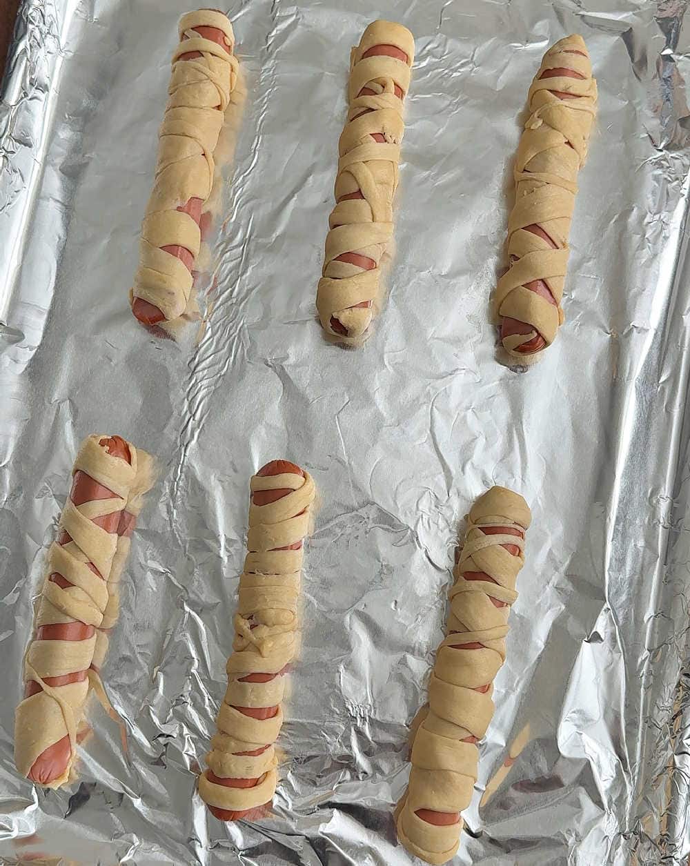 baking hot dogs on tray.