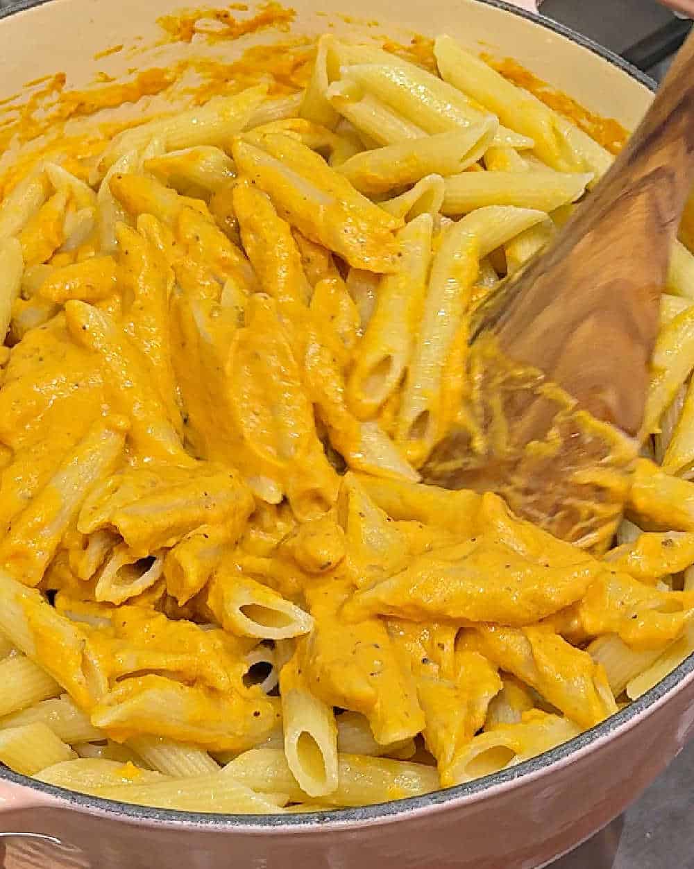 stirring sauce and pasta.