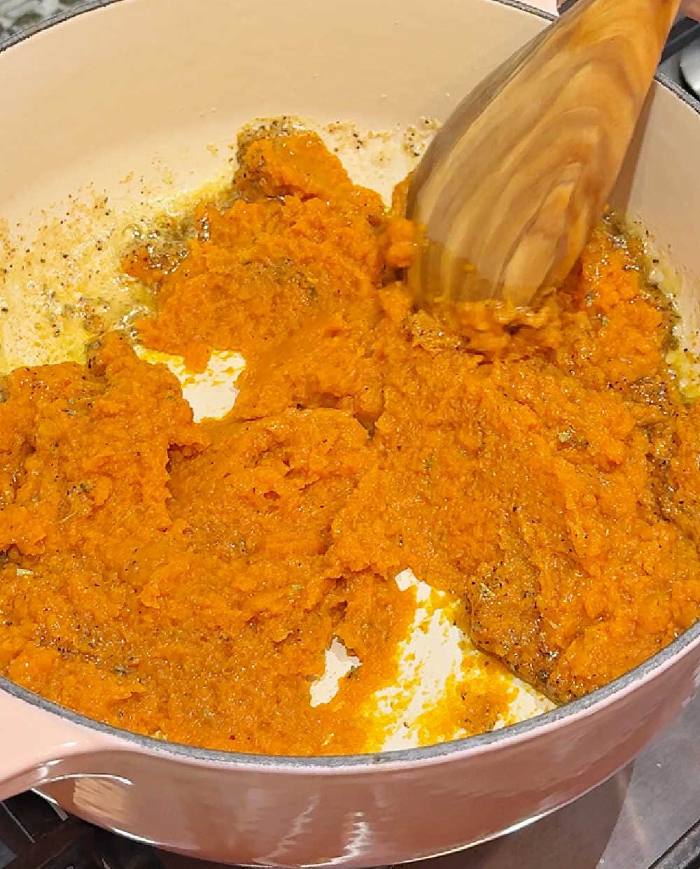 stirring pumpkin in Dutch oven.
