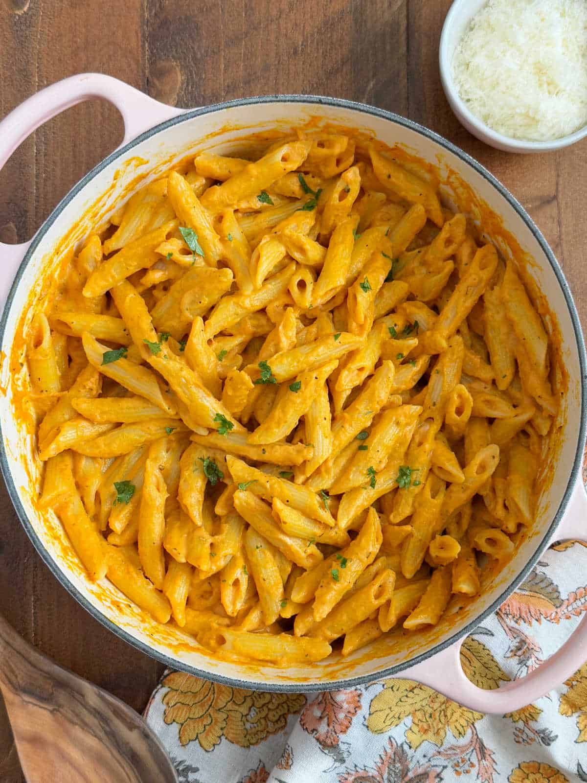 penne pasta with pumpkin pasta sauce and parsley in Dutch oven.