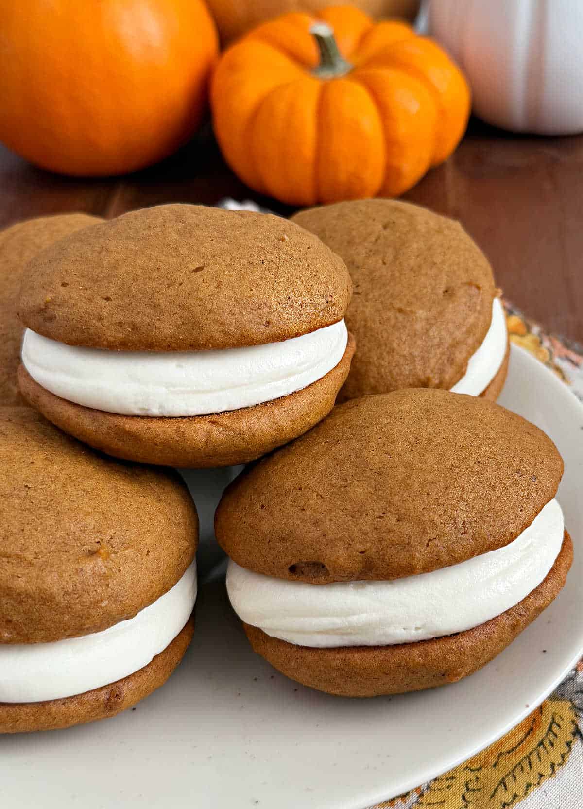 plate of pumpkin whoopie pies on the table.