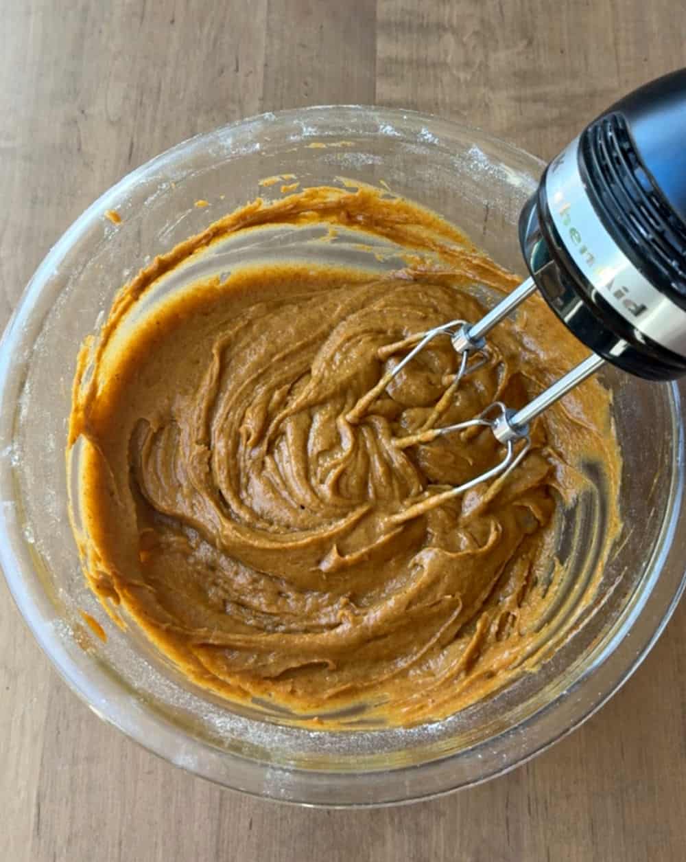 mixing pumpkin batter in mixing bowl.
