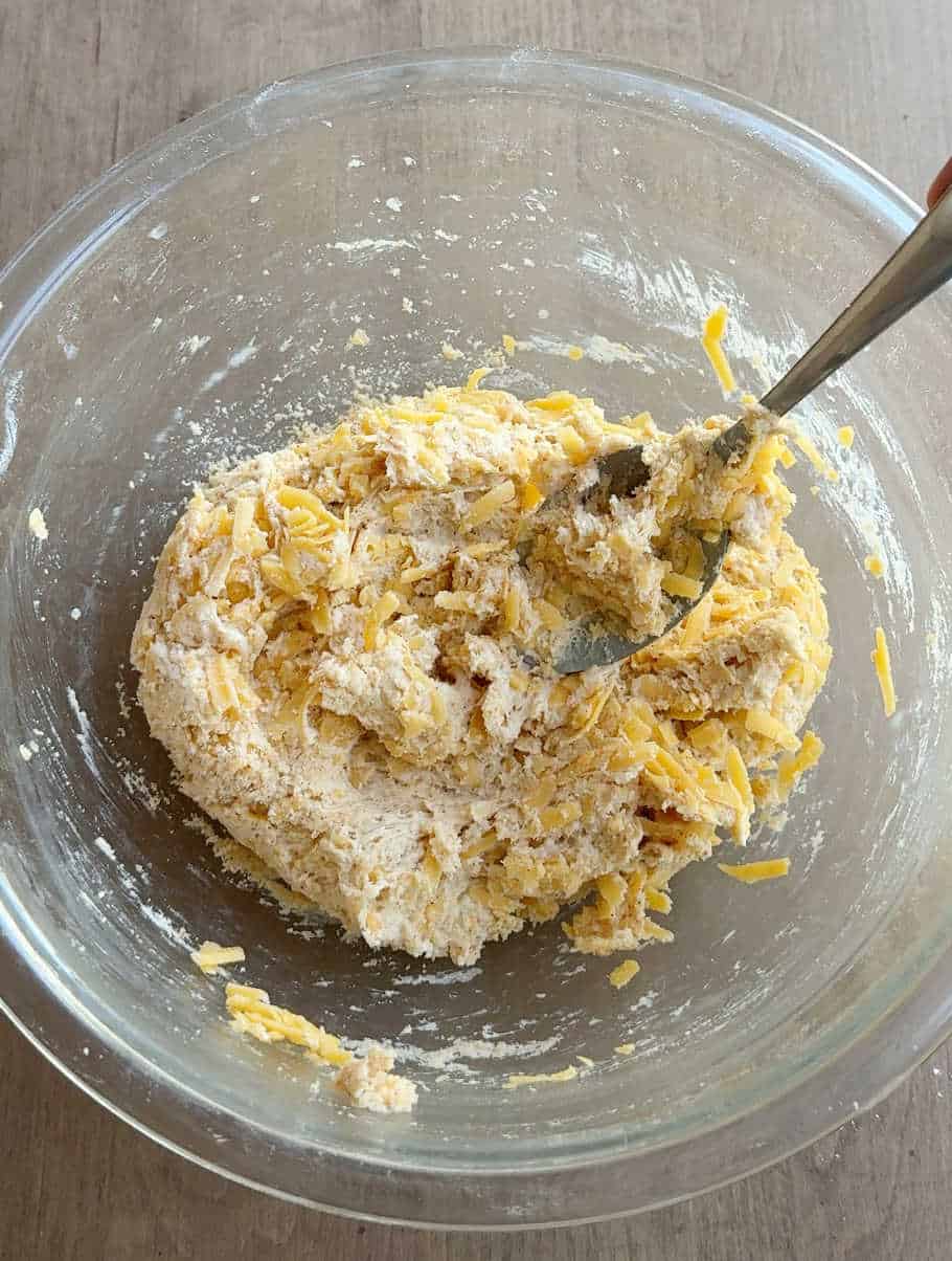 mixing cheese into dough.