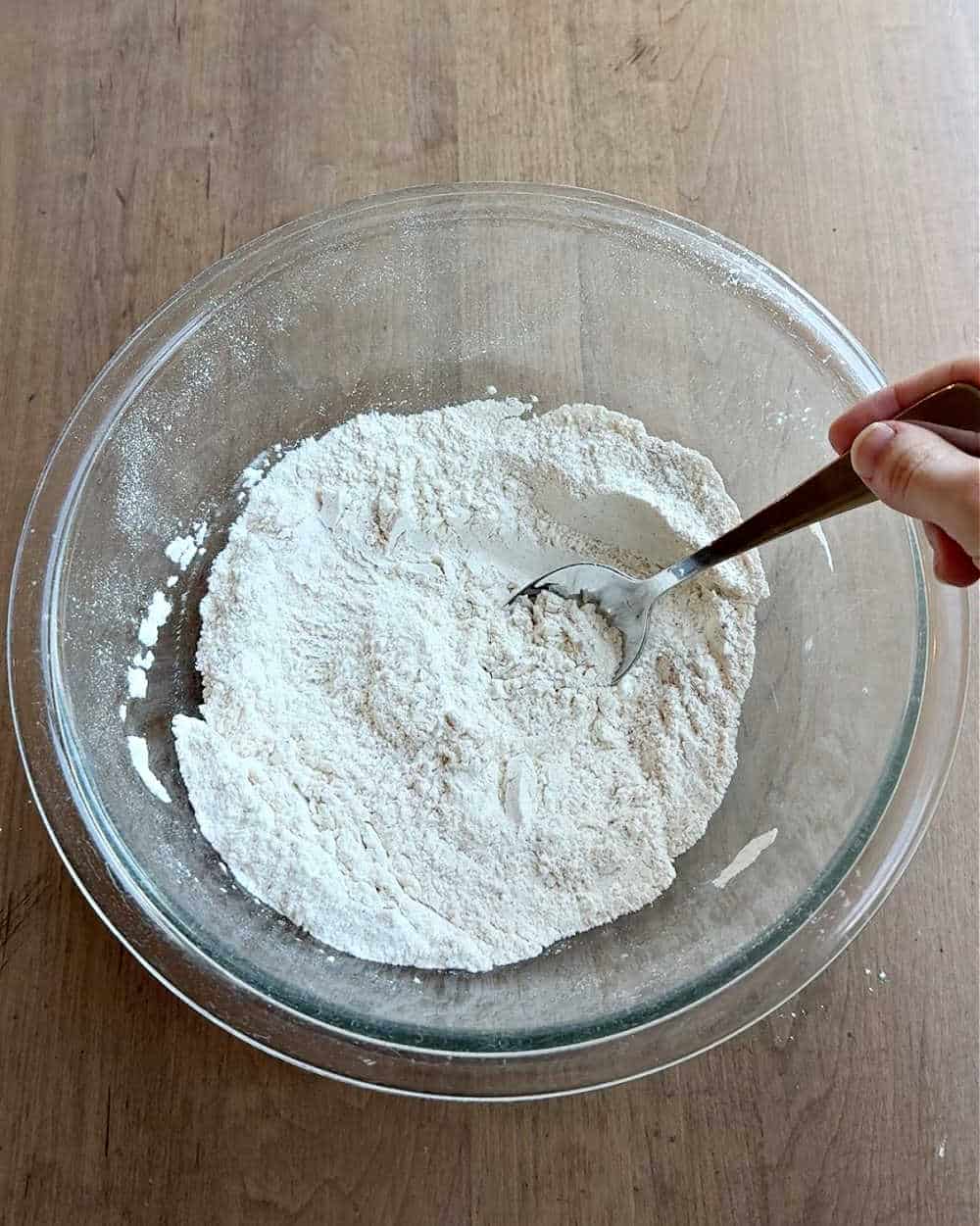mixing dry ingredients with spoon.