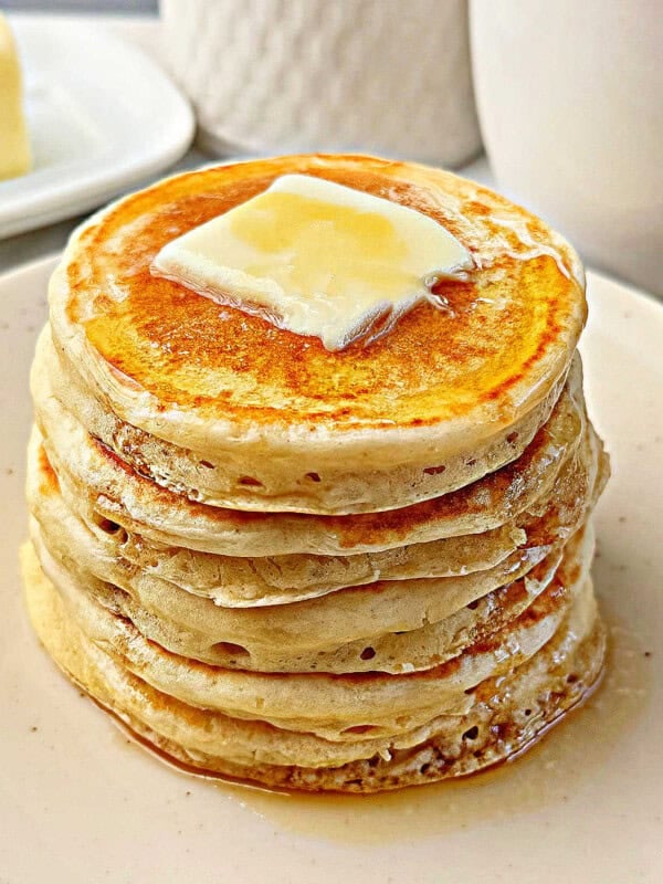 fluffy sourdough pancakes with butter and maple syrup.