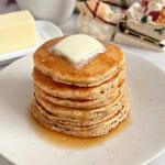 eggnog pancakes with butter and maple syrup.