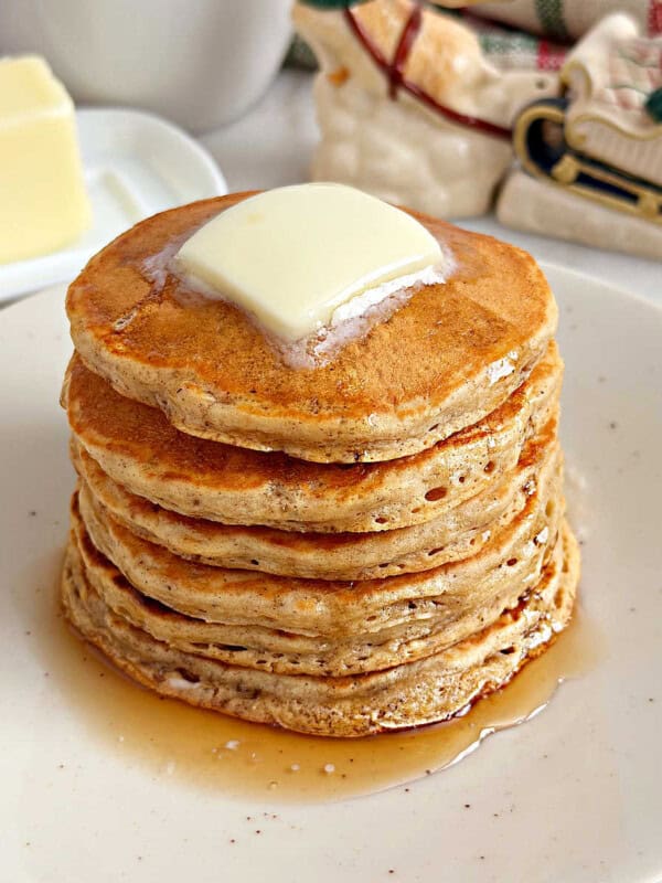 eggnog pancakes with butter and maple syrup.