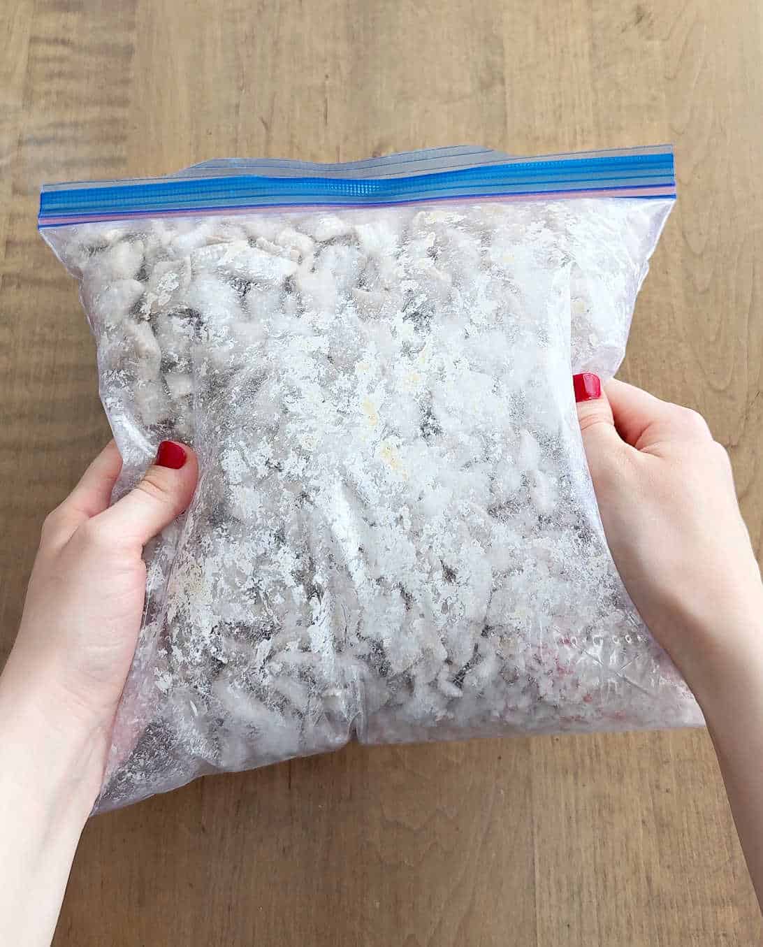 shaking puppy chow mixture in freezer bag.