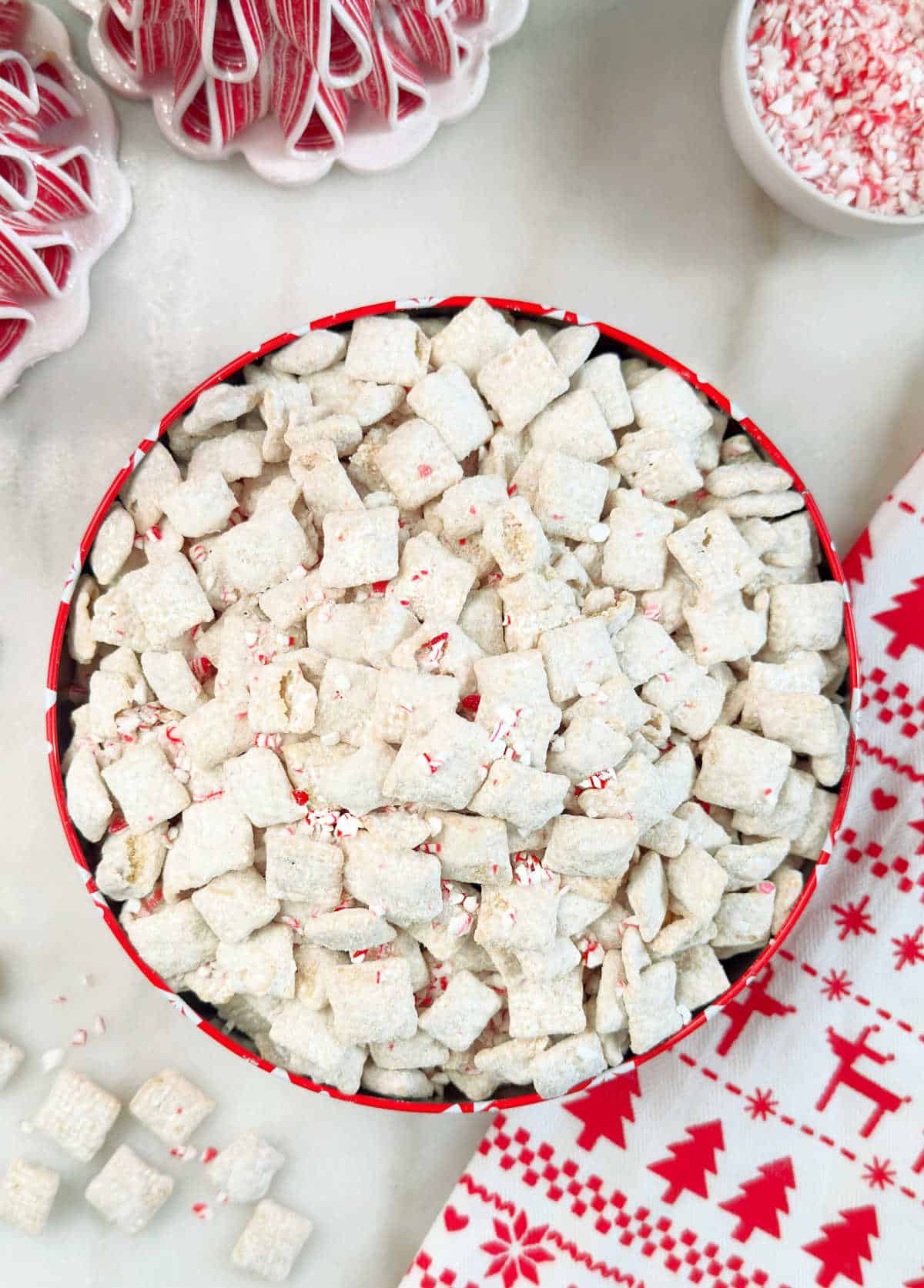 peppermint puppy chow in a bowl with crushed candy canes.