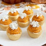 pumpkin cheesecake cookie cups on a plate.