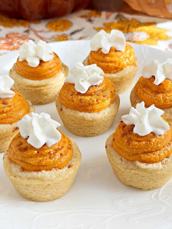 pumpkin cheesecake cookie cups on a plate.