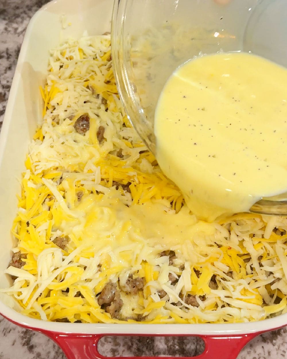 pouring eggs on top of casserole.