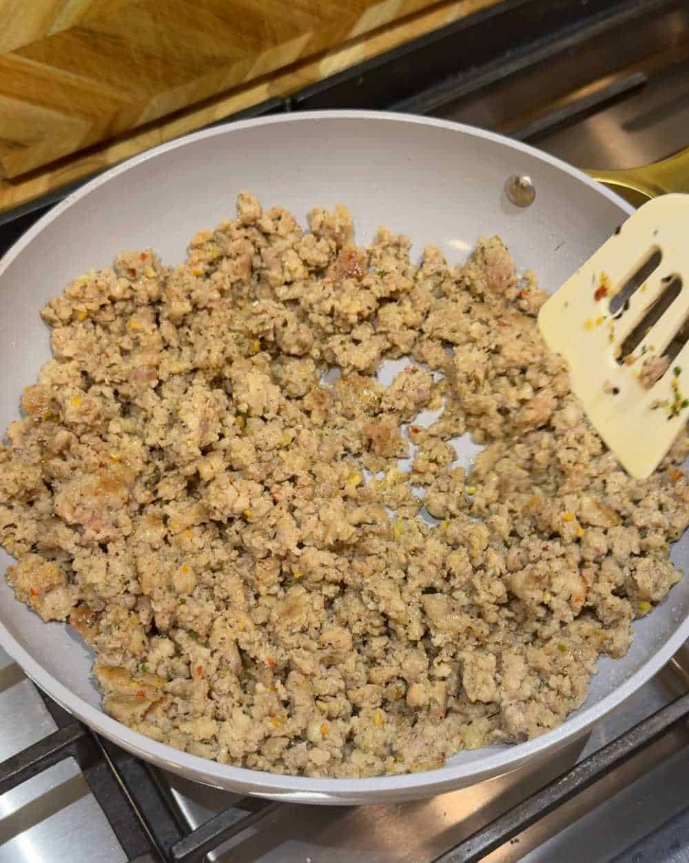 cooking breakfast sausage in caraway pan.