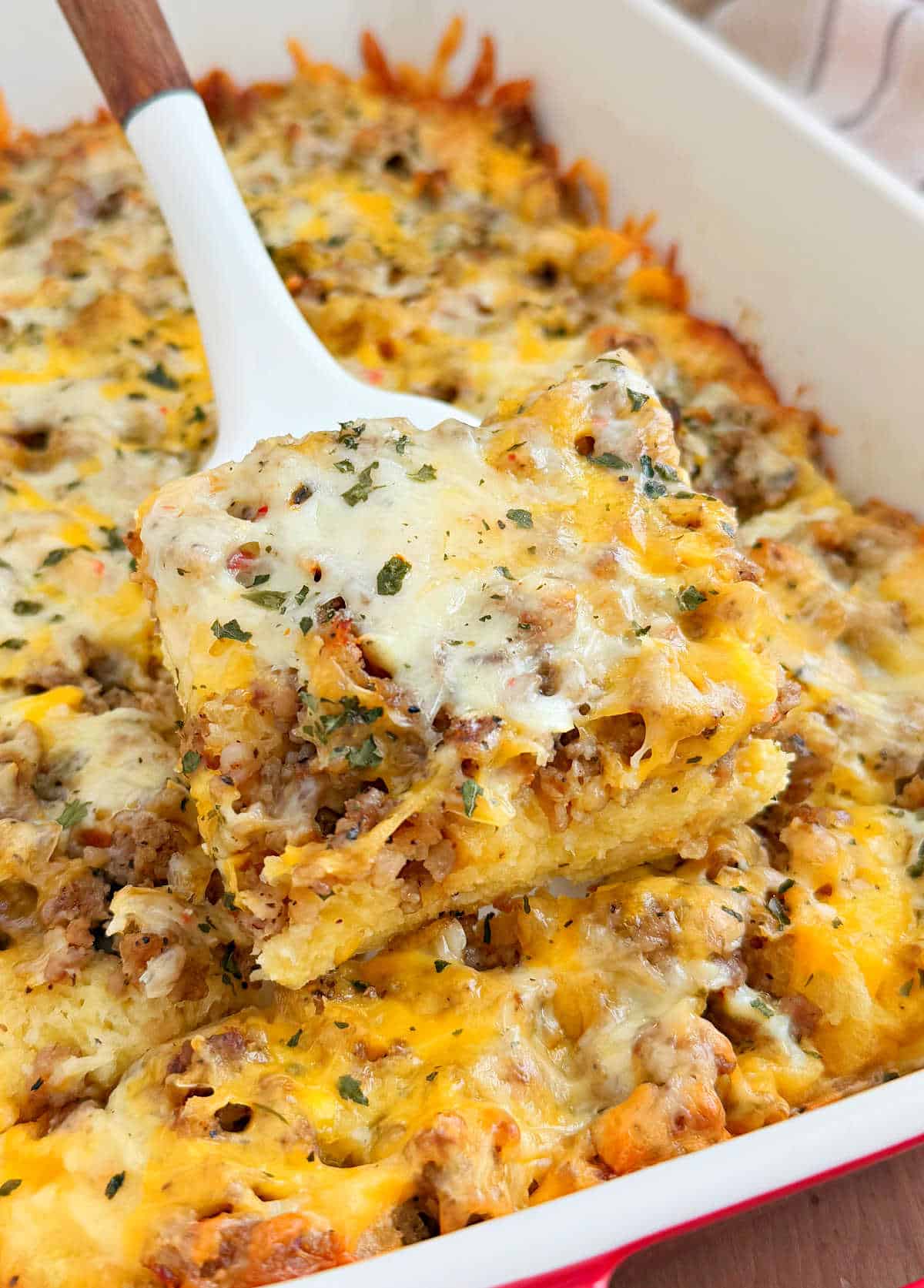 sausage egg and cheese breakfast casserole on a spatula.