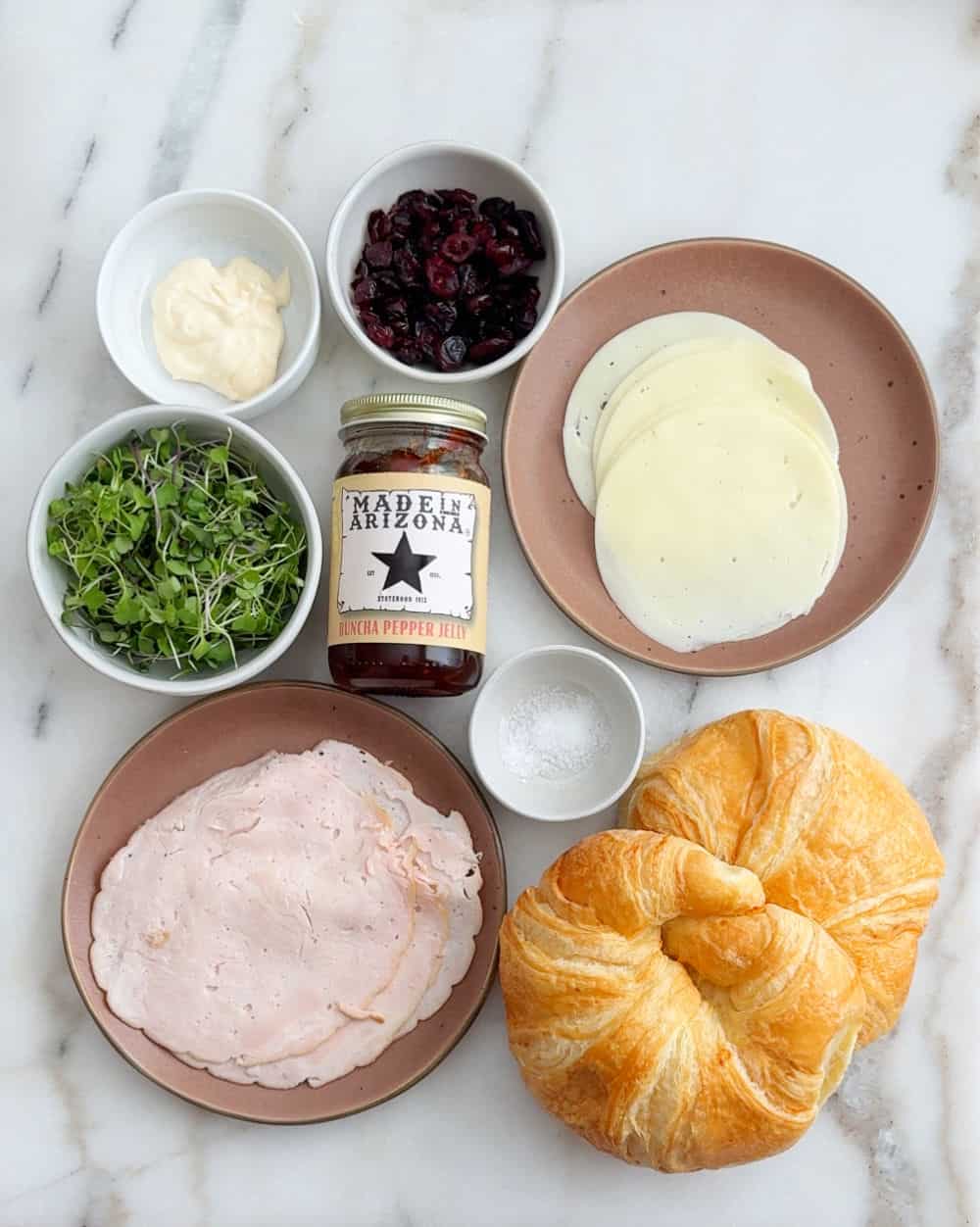 turkey meat, microgreens, mayo, craisins, salt, pepper jelly, cheese, croissants.