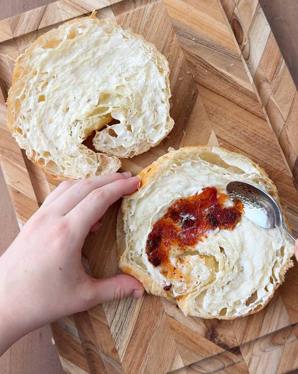 spreading mayo and jelly on bread.