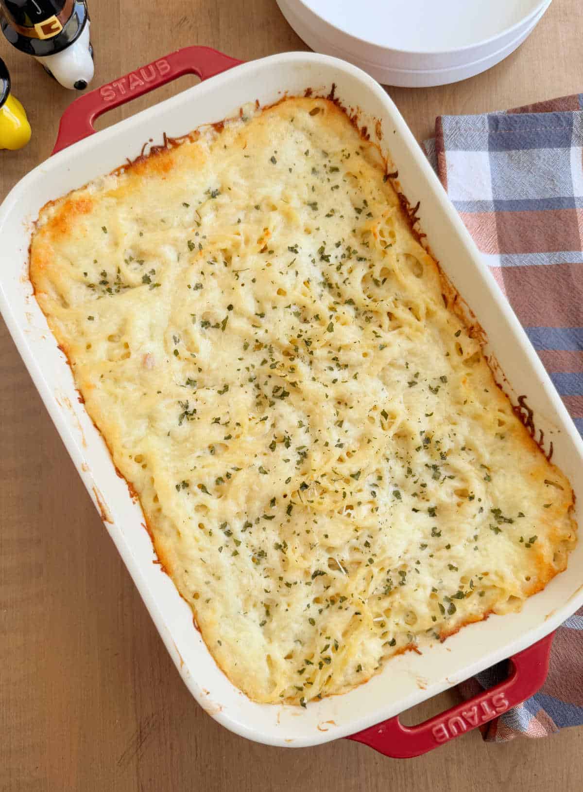 baked turkey tetrazzini in a red casserole dish.