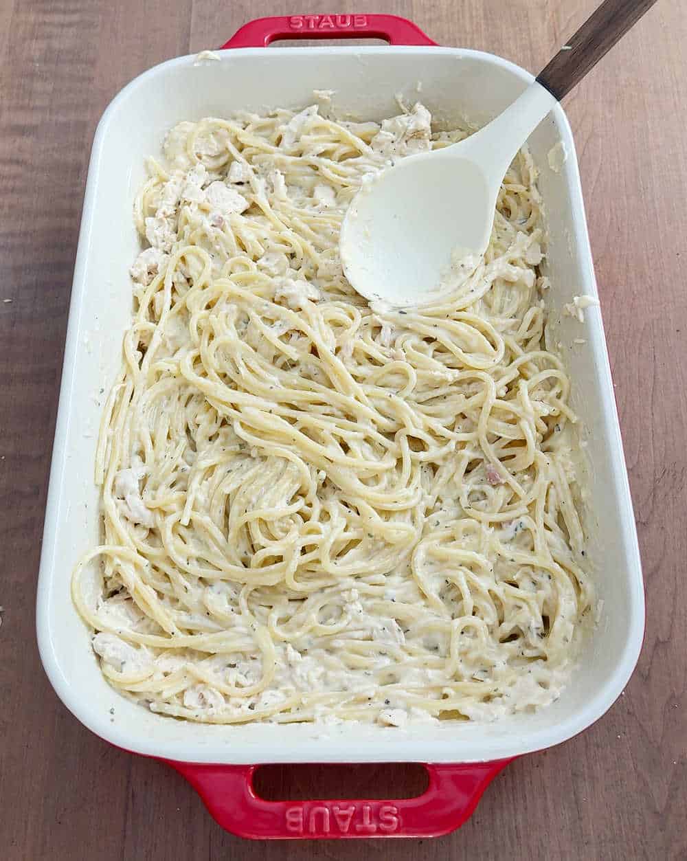 stirring ingredients in casserole dish.