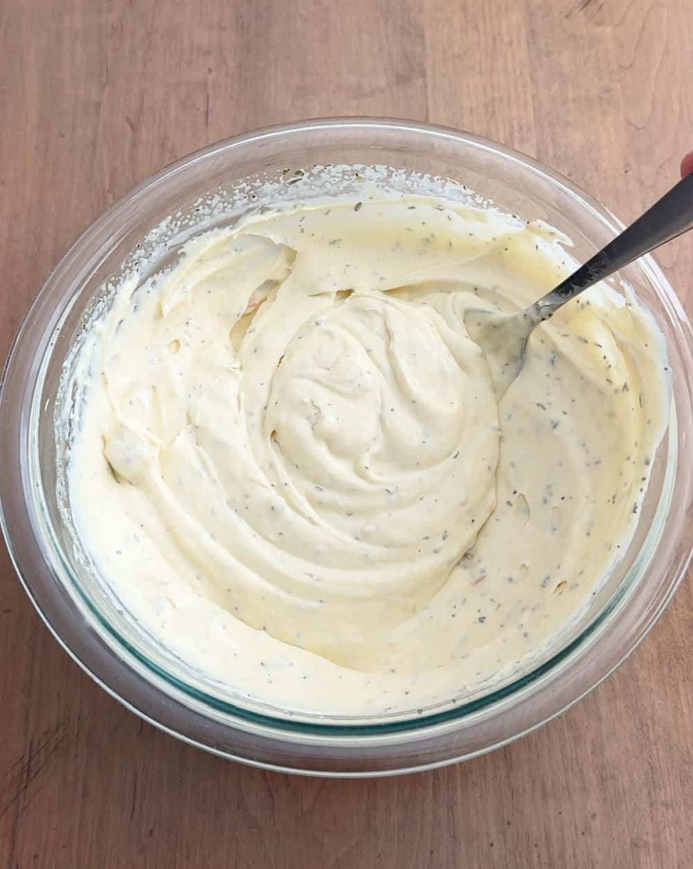 mixing sauce in mixing bowl.