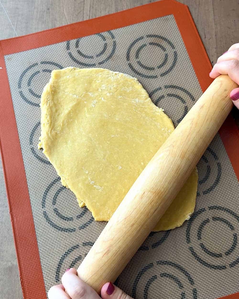 rolling dough out with rolling pin.