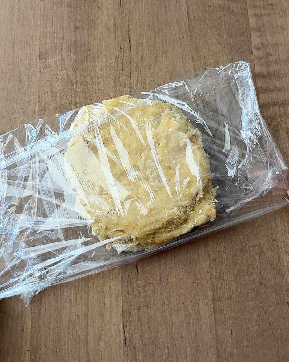 wrapping dough in plastic wrap.