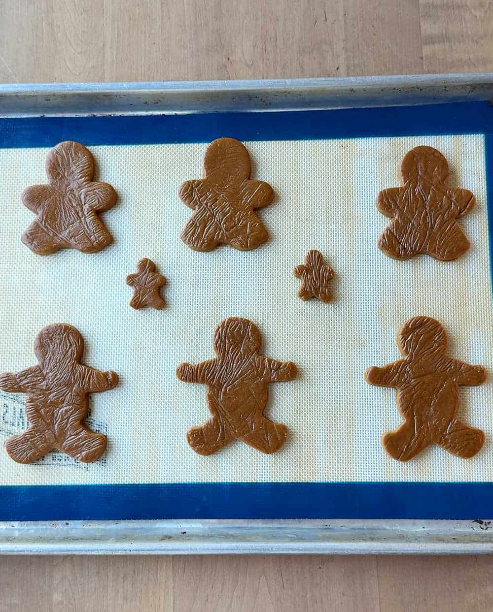 gingerbread people shapes on baking sheet.