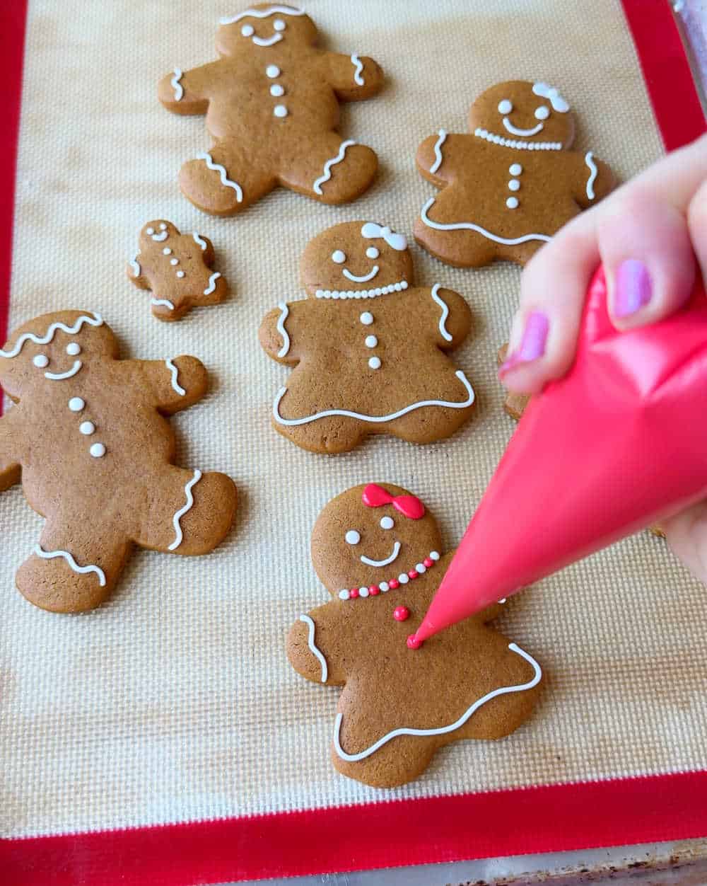 decorating gingerbread cookie with royal icing.