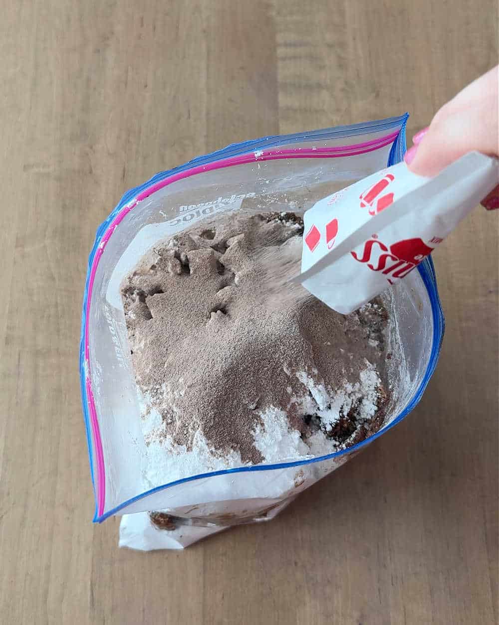 adding hot chocolate mix to bag.