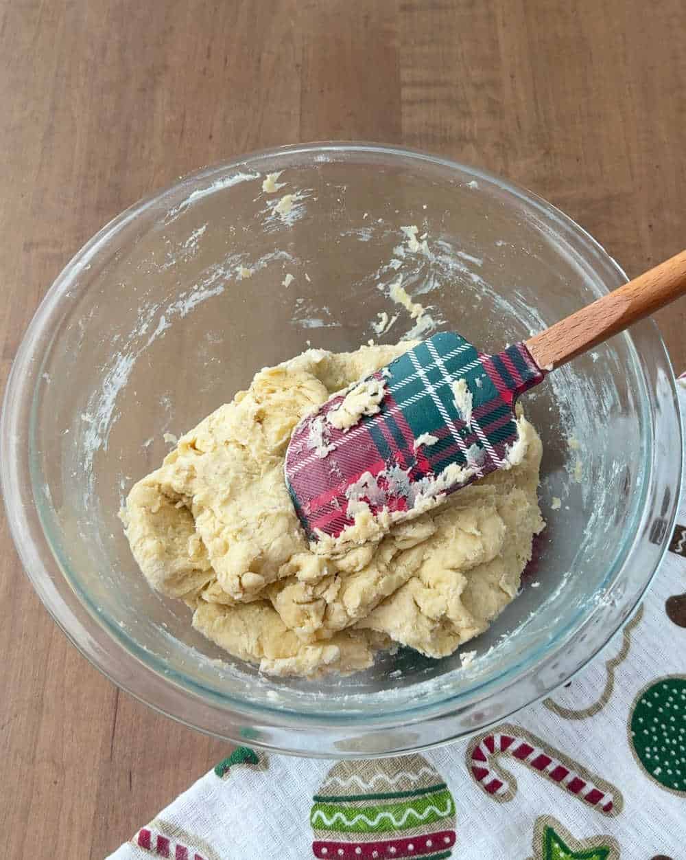 mixing dough with plaid spatula.
