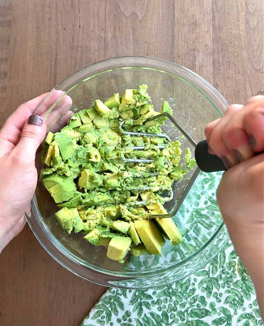 mashing avocado in mixing bowl.