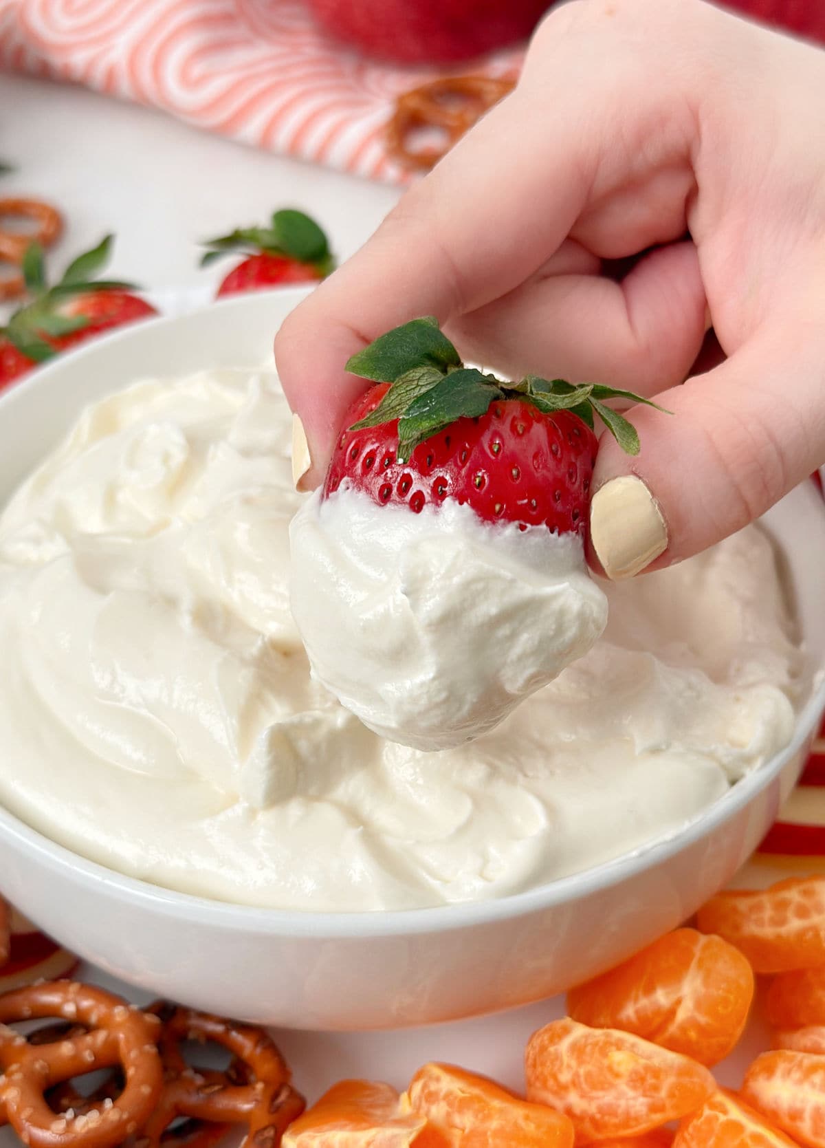 dipping strawberry into fruit dip.