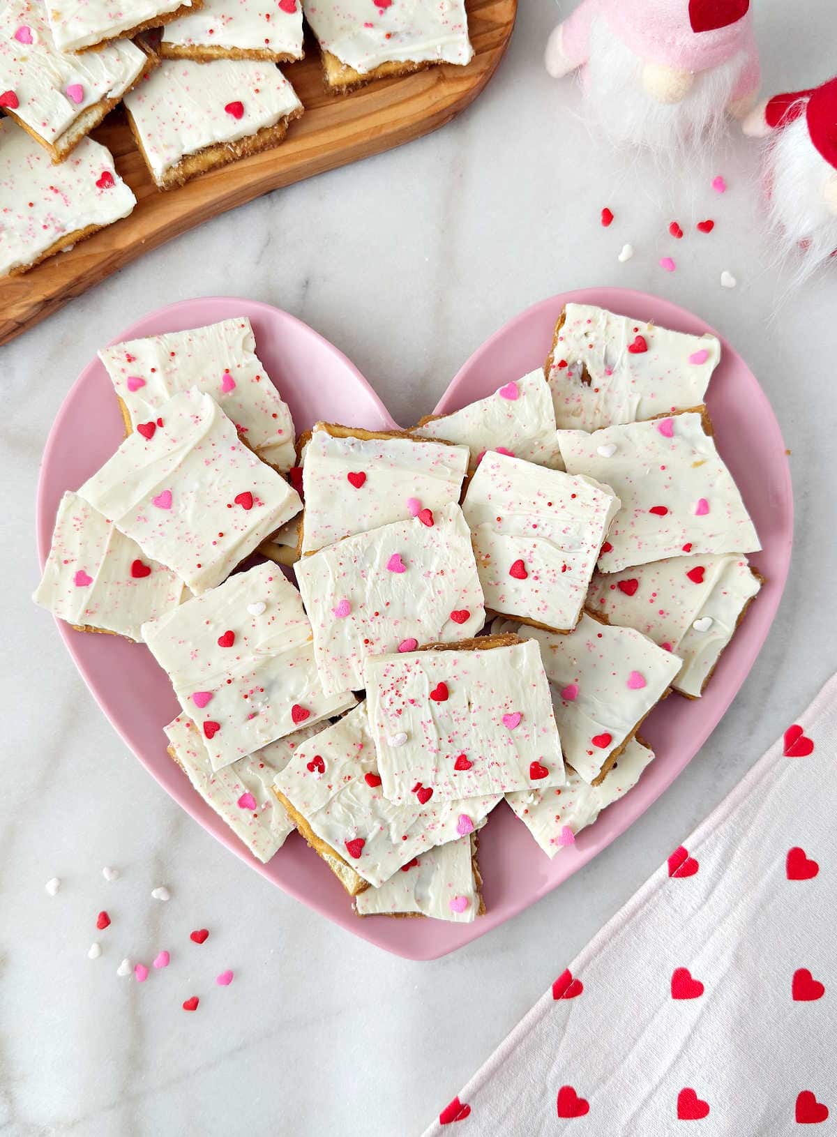 White chocolate Valentines crack candy on heart shaped plate.
