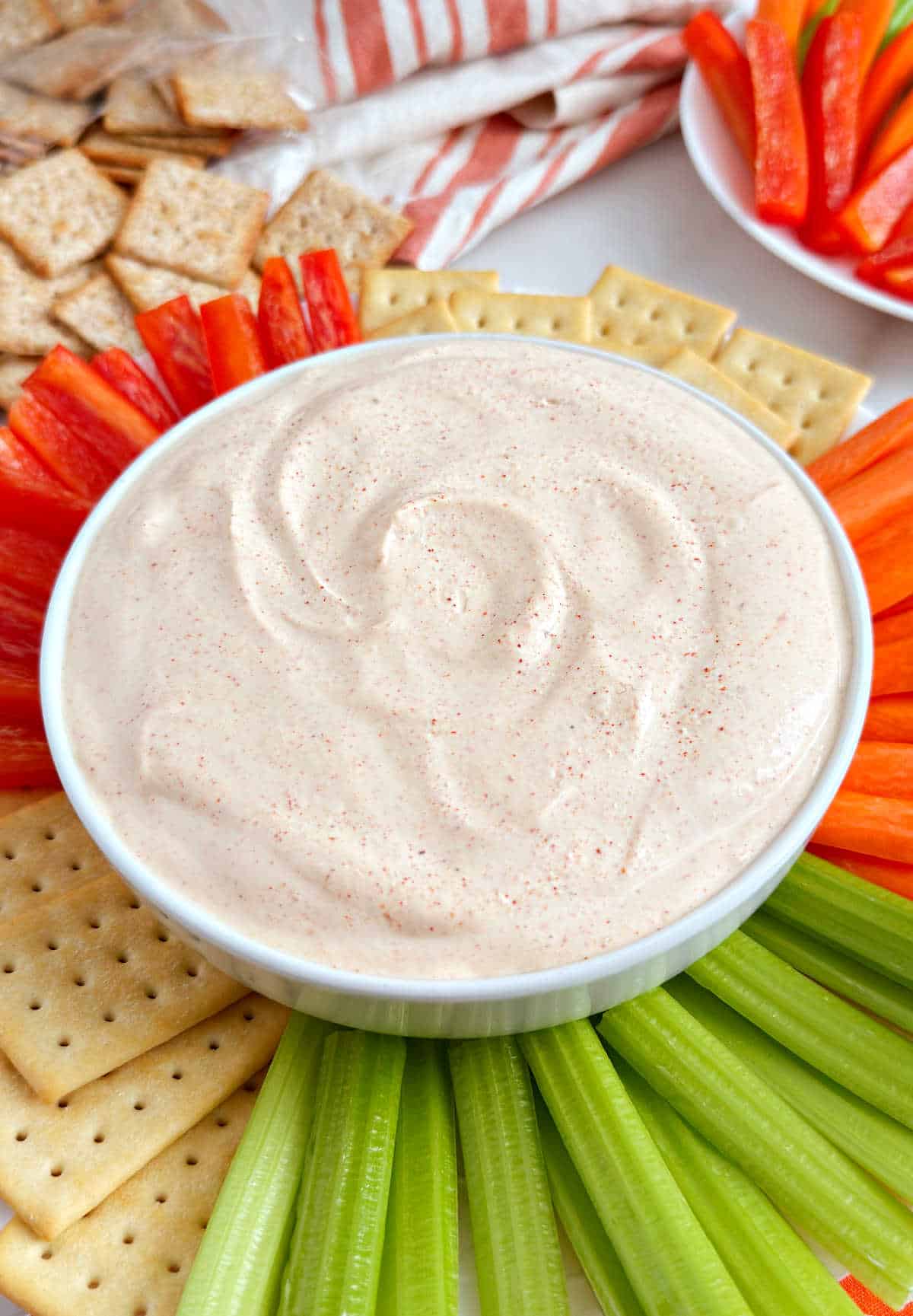 bowl of ghost pepper dip with fresh veggies and crackers.
