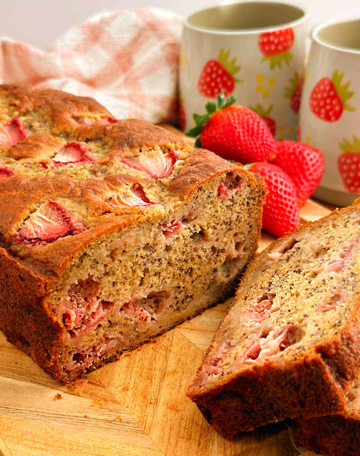 strawberry banana bread slices on cutting board.