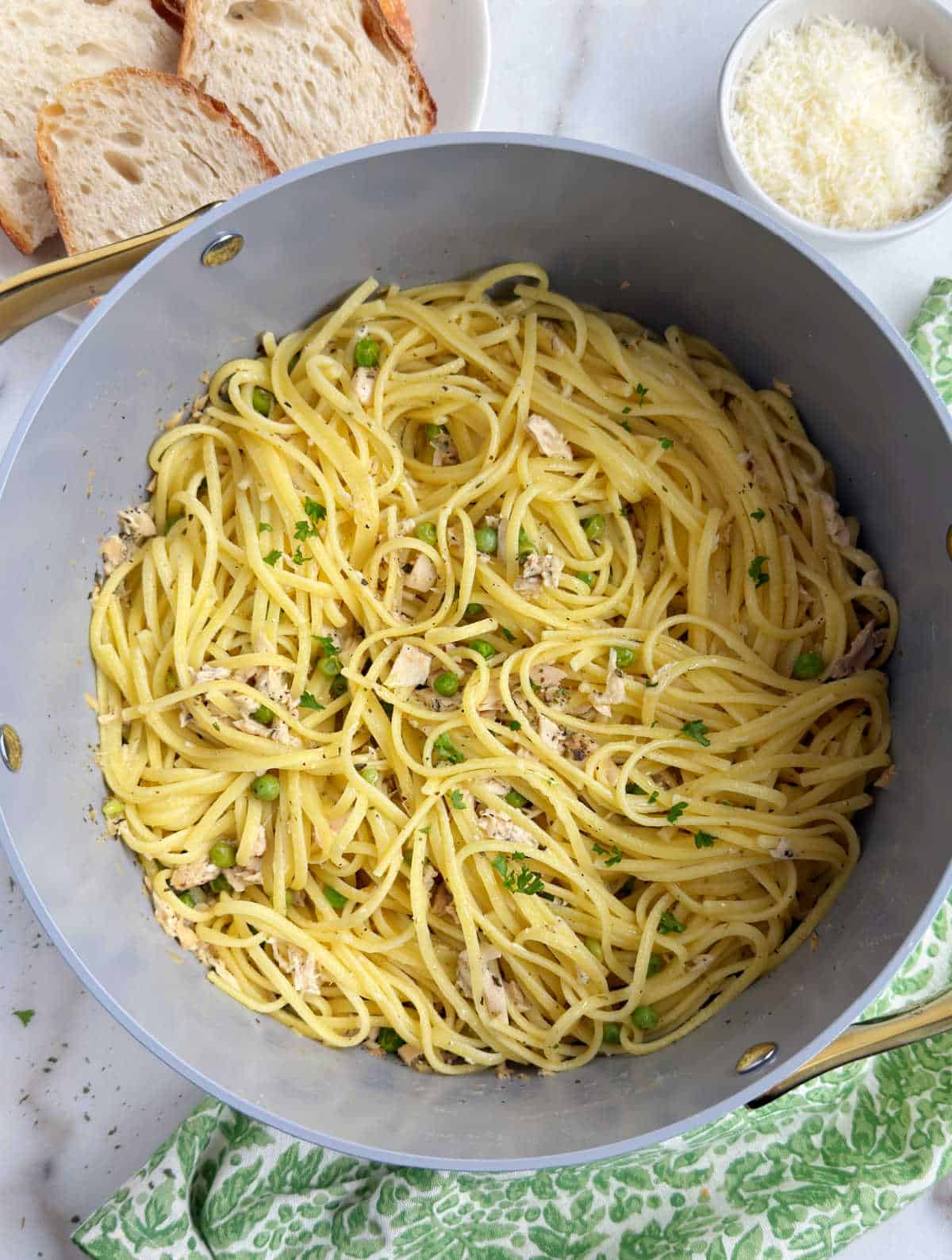 cooked pasta with tuna and peas in dutch oven.
