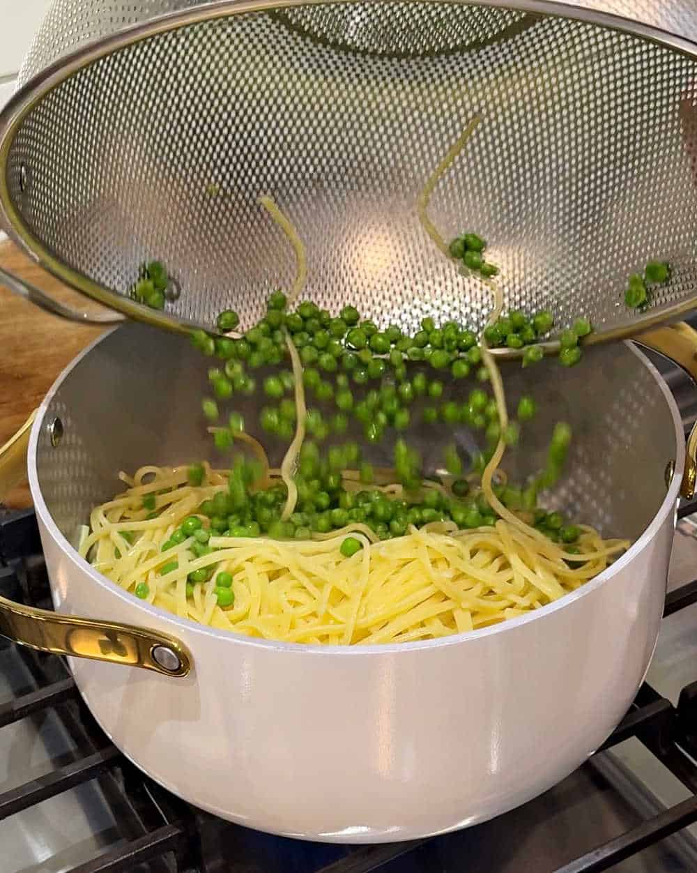 adding peas and linguine.