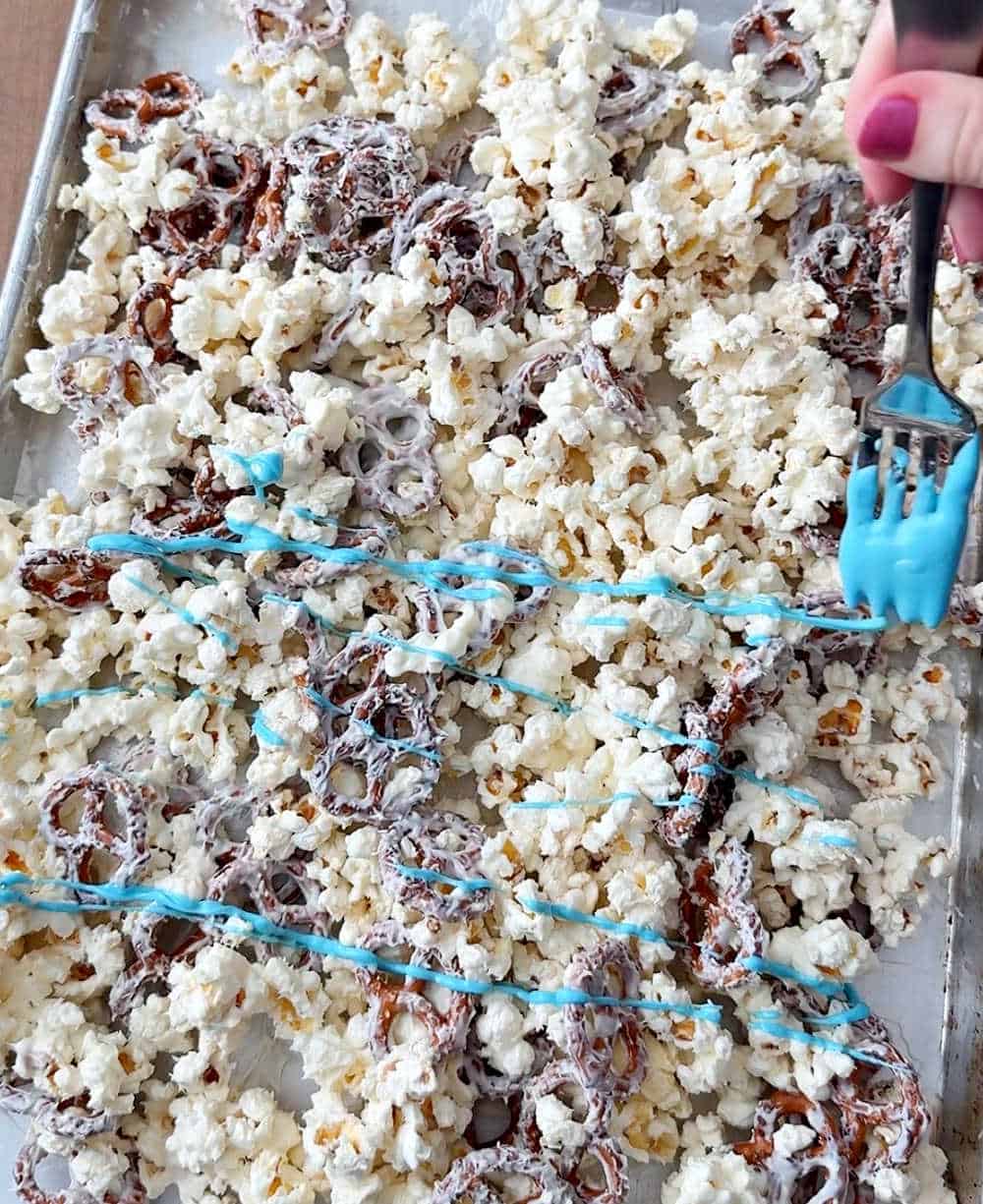 drizzling candy coating on mixture.