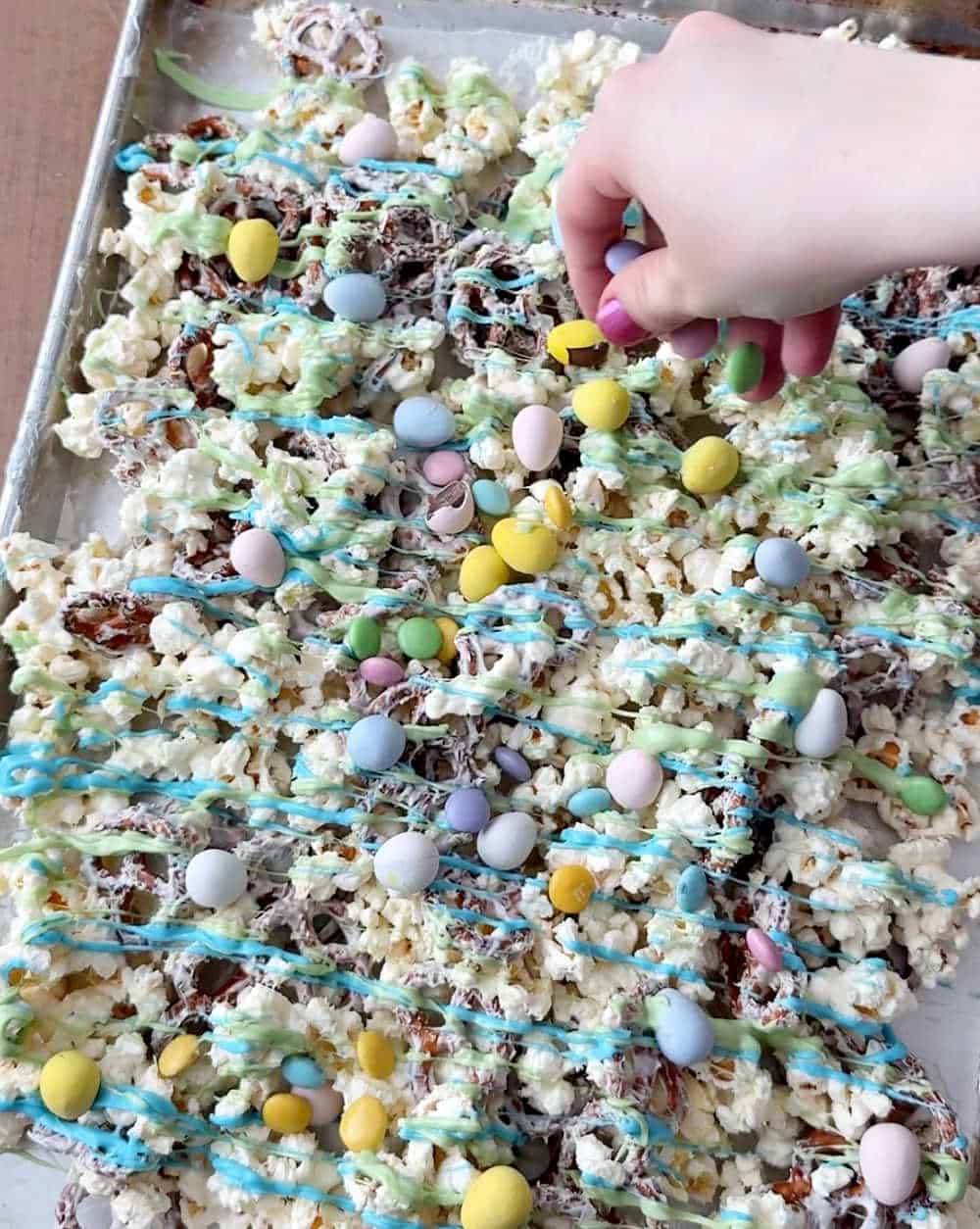 tossing Easter candies into popcorn mixture.